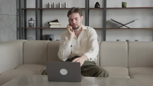 Young Adult Businessman Having a Job Call Conversation in His Office