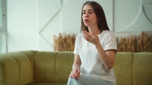 Young Woman Appearing Sick on Couch