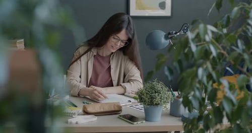 Beautiful Lady Illustrator Drawing Picture and Smiling Working in Creative Art Studio Alone