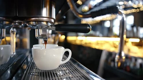 Priofessional Coffee Machine Pours Coffee Into a Cup in a Restaurant