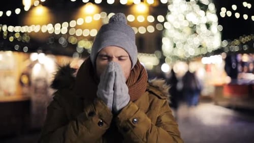 Smiling man in winter clothes at christmas market