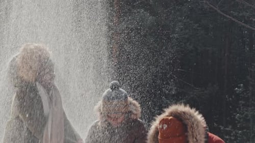 Joyful Family Playing With Snow