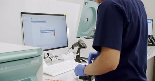 Lab Technician Working With Samples and Computer