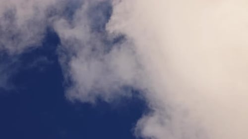 White Cloud Moves Quickly and Changes Shape Against the Blue Sky Cloud Movement in Closeup