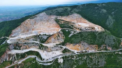 Natural Quarry is Located Near Road Against Backdrop of Rhodope Mountains and Hills with Forests and