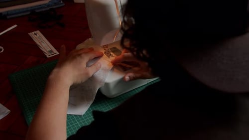 Woman Sewing Fabric with a Sewing Machine