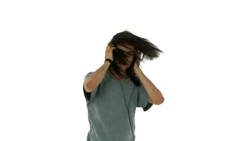 Young man with headphones rocking out to music in the studio