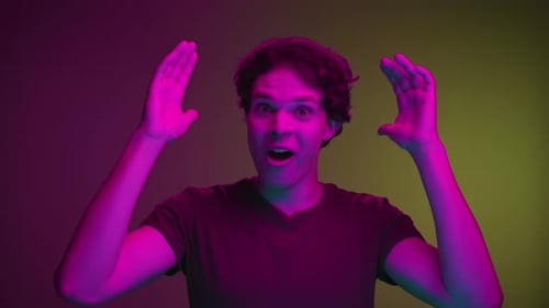 Man Reacting with Surprise and Raising Hands