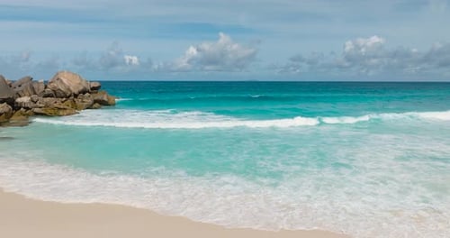 White Sand Beach with Turquoise Waves and Granite Rocks Seychelles La Digue