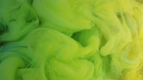 Green and Yellow Paint Swirls in Water