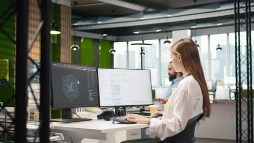 Woman Coding at Computer Workstation in Modern Office