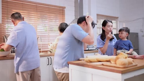 Happy Family Prepares Food Together in the Kitchen