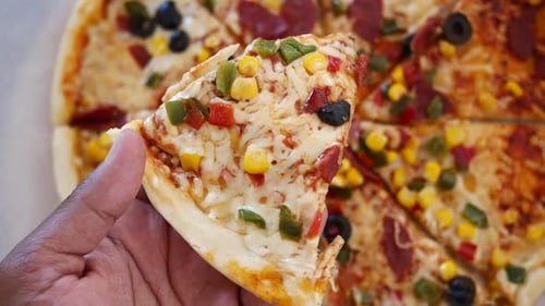 Close Up View of Pizza Slice with Toppings