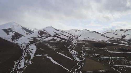 Drone Over Cross On Snowy Mountain Peak