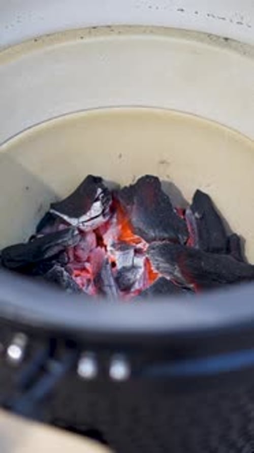 Smouldering coals in a kamado grill, close up view
