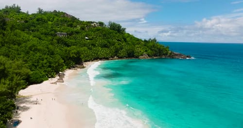 Turquoise Ocean with Waves Hitting a White Sandy Beach Seychelles Mahe