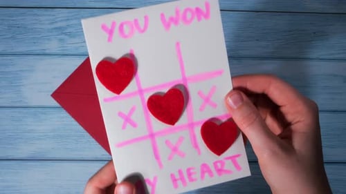Handmade Heart Tic-Tac-Toe Card on Blue Wood