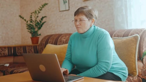 Senior Woman with Laptop Working at Home Office