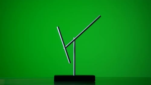 Magnetic Pendulum Balancing on Green Background