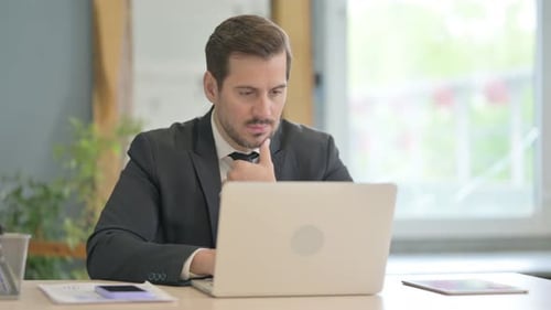 Focused Businessman Working On Laptop