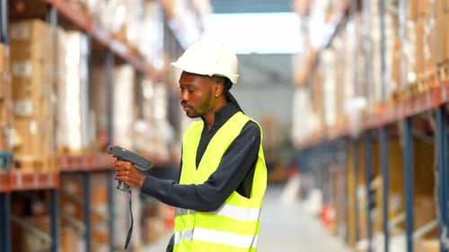 Warehouse Worker Scanning Inventory with Barcode Scanner
