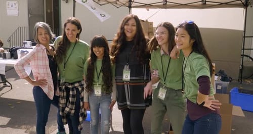 Portrait Happy Volunteers Posing in Sunny Parking Lot 2024 Years