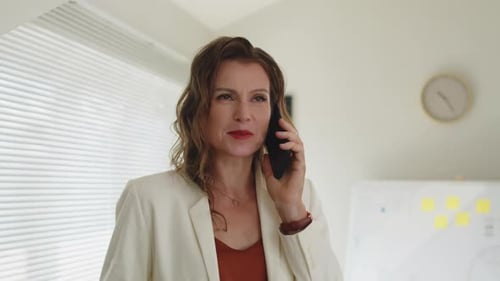 Professional Woman Talking on Phone in Office