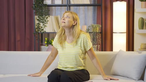 Distressed Woman Displaying Fear and Anxiety Indoors