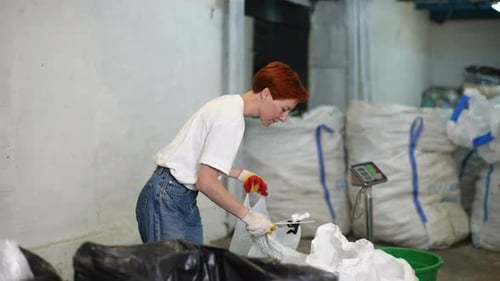 Woman Sorting Recyclable Trash Indoors