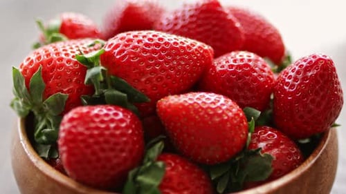 Juicy ripe strawberries in wooden bowl. Summer farm berries.