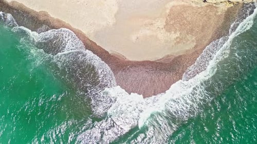 Aerial top down shot of waves reaching the shore at Tortuga Island, Costa Rica.