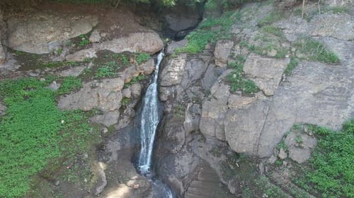 Waterfall Cascading Down Rocky Cliffside from Above