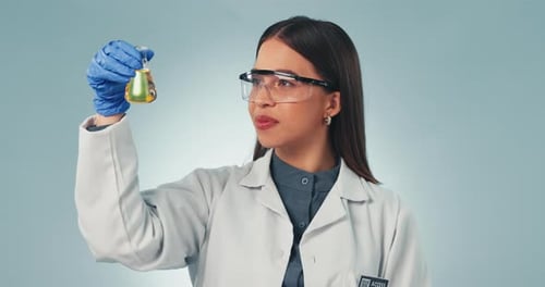 Doctor, thumbs up and sample with a science woman in studio on a gray background for research