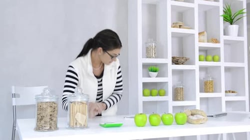 Woman Calculates Calories on Scale with Healthy Food