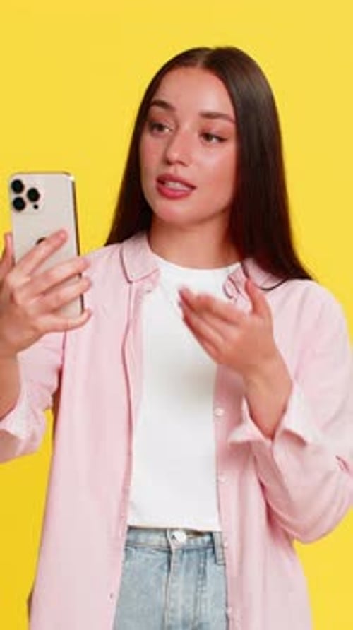 Happy Woman Video Calling on Smartphone, Yellow Background