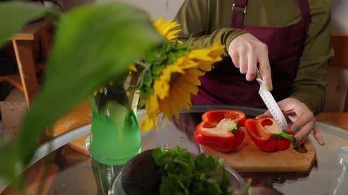 Closeup View of Female Hands Extracting Seeds From the Bell Pepper Using Knife