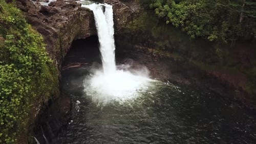 Cinematic Drone Shot panning up and revealing a gushing Rainbow Falls right after a rain storm.