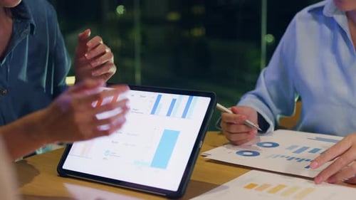 Asia businesspeople meeting plan analysis statistics brainstorm at office night.