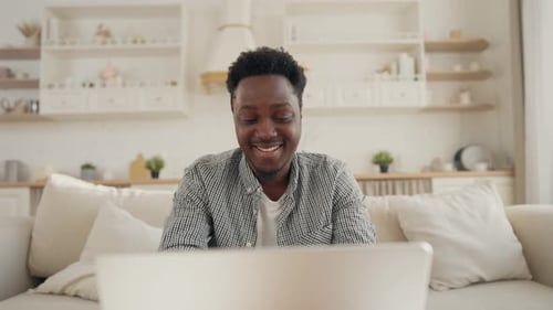 Young Man Working on Laptop at Home