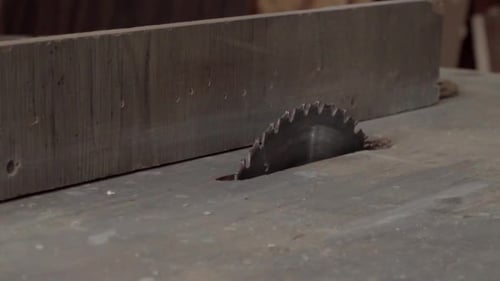 A moving shot of a table saw in a carpentry workshop