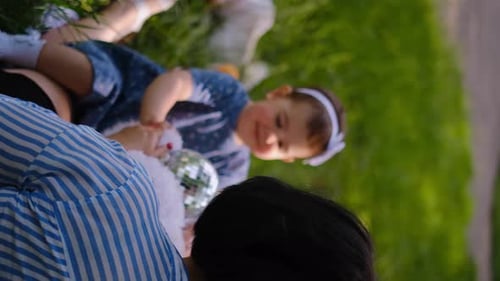 Mother and child together in the park outdoors, lying in the grass. Motherhood happiness concept. Da