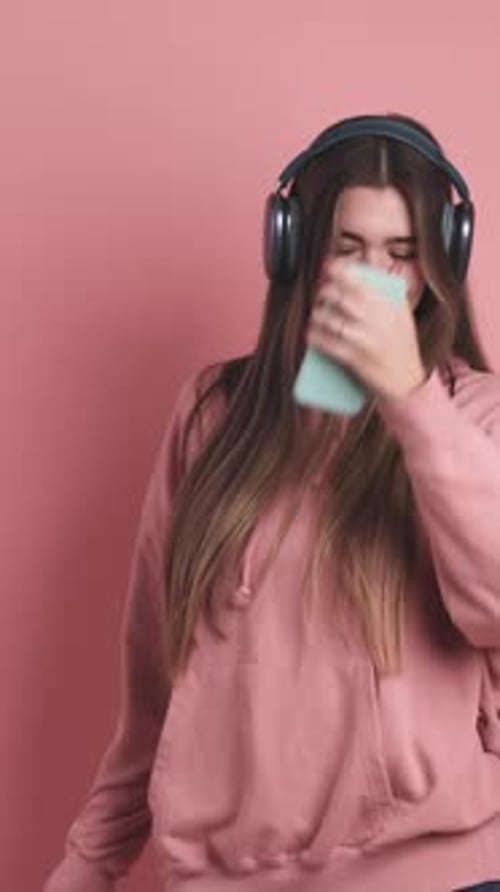 Woman Listens to Music and Dances