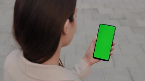 Back View of the Woman Holding the Green Screen Smartphone Chroma Key Mobilephone Technology Cell