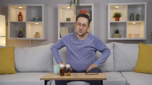 Man Massaging Shoulder in Home Setting