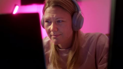 Close Up View of Girl in Headphones Who Play Online Game Strategy or Shooter