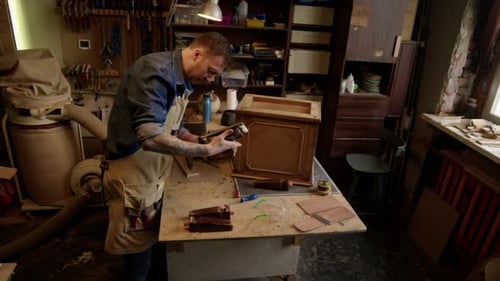 Repairman Restoring Old Furniture in Workshop