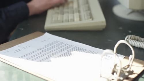 Man Typing on Computer at Desk in Office