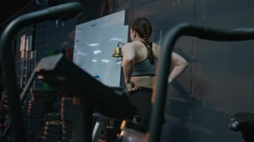 Woman Using Air Bike at the Gym