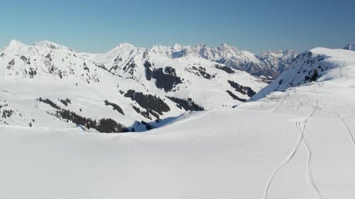 Hiker Trekking On Snow-covered Mountain Reiterkogel In Winter In Hinterglemm, Austria. aerial shot