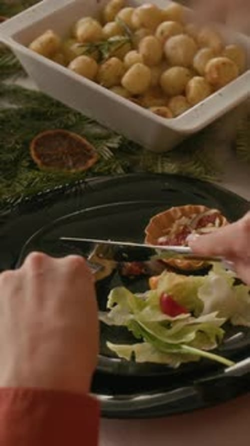 Anonymous Girl Cutting Piece of Cheese and Eating at Winter Themed Table